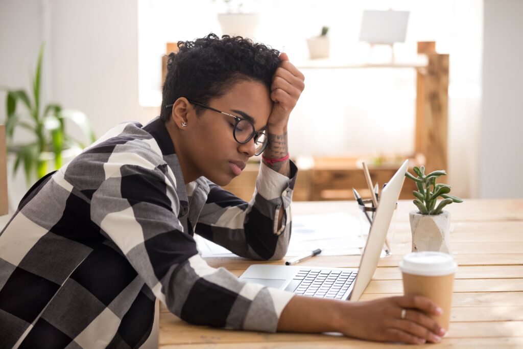 African woman sitting at the desk at office and sleeping African woman sitting at the desk at office and sleeping